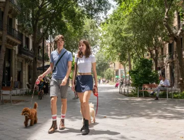 Couple walking with a dog in Barcelona