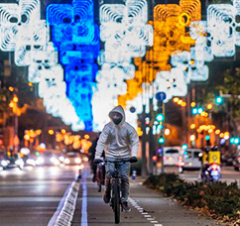 Cyclist riding along an illuminated Barcelona street